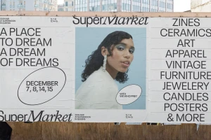 Large outdoor paste-up poster displaying typography, event dates, and a portrait of a woman in profile against a light background