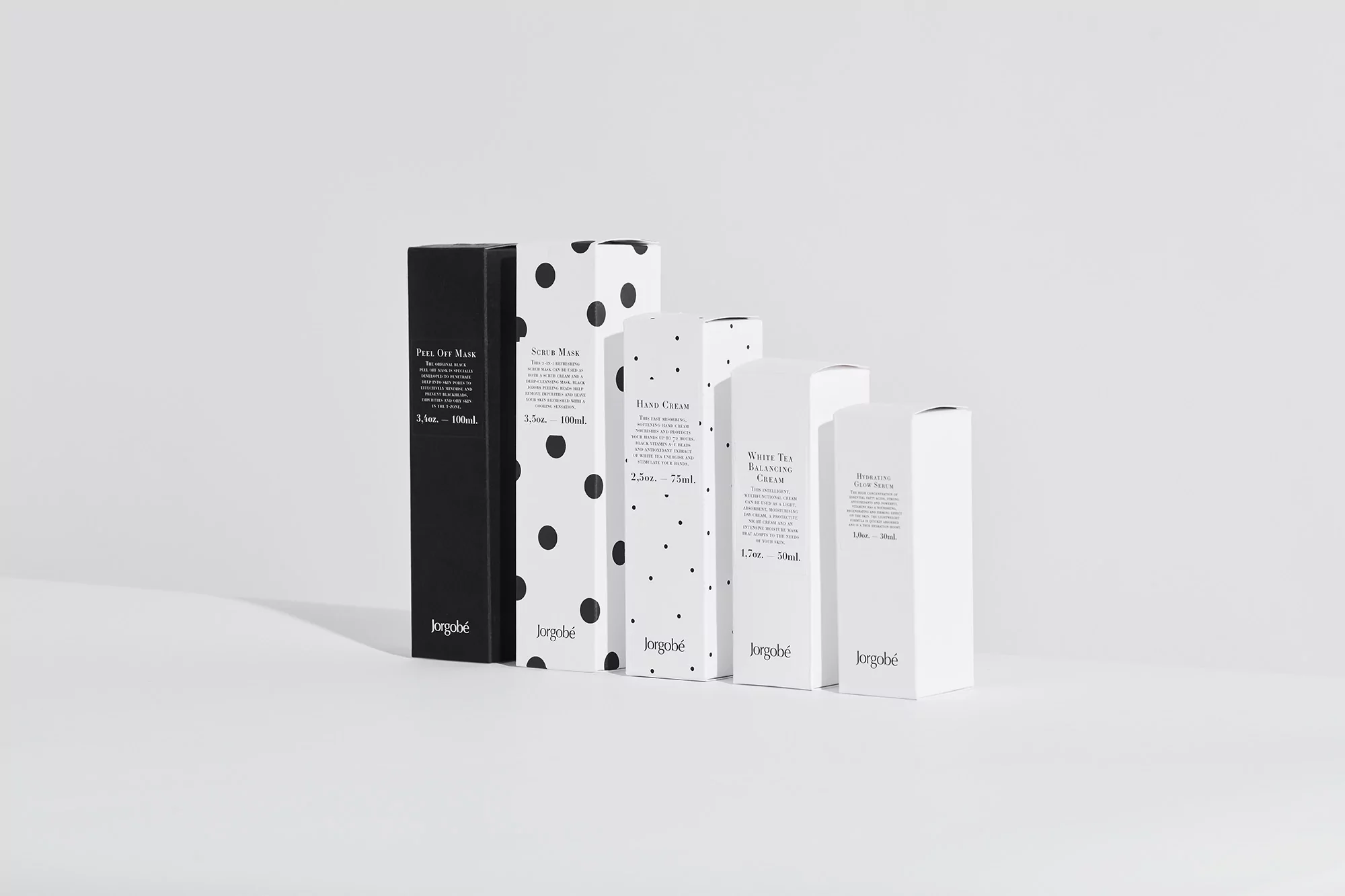 Product packaging in minimalist black, white and polka dot design, featuring Jorgobé branded skin care creams and masks.