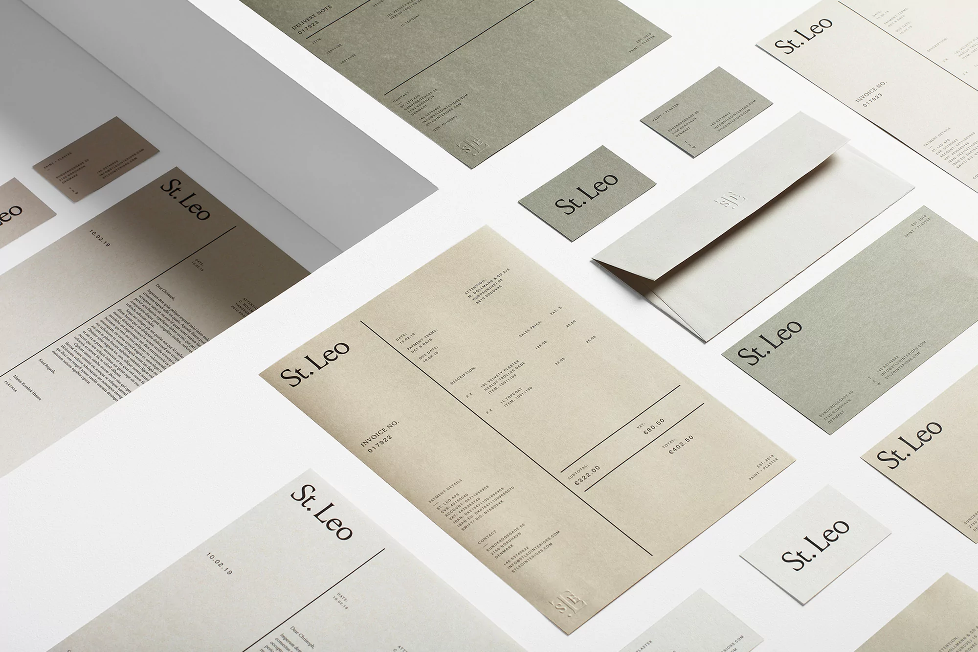Various stationery items including letterhead, business cards, and an envelope are arranged on a clean white surface, branded with St. Leo.