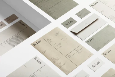 St. Leo brand identity collateral including letterheads, business cards, envelopes, and invoices in earthy tones.