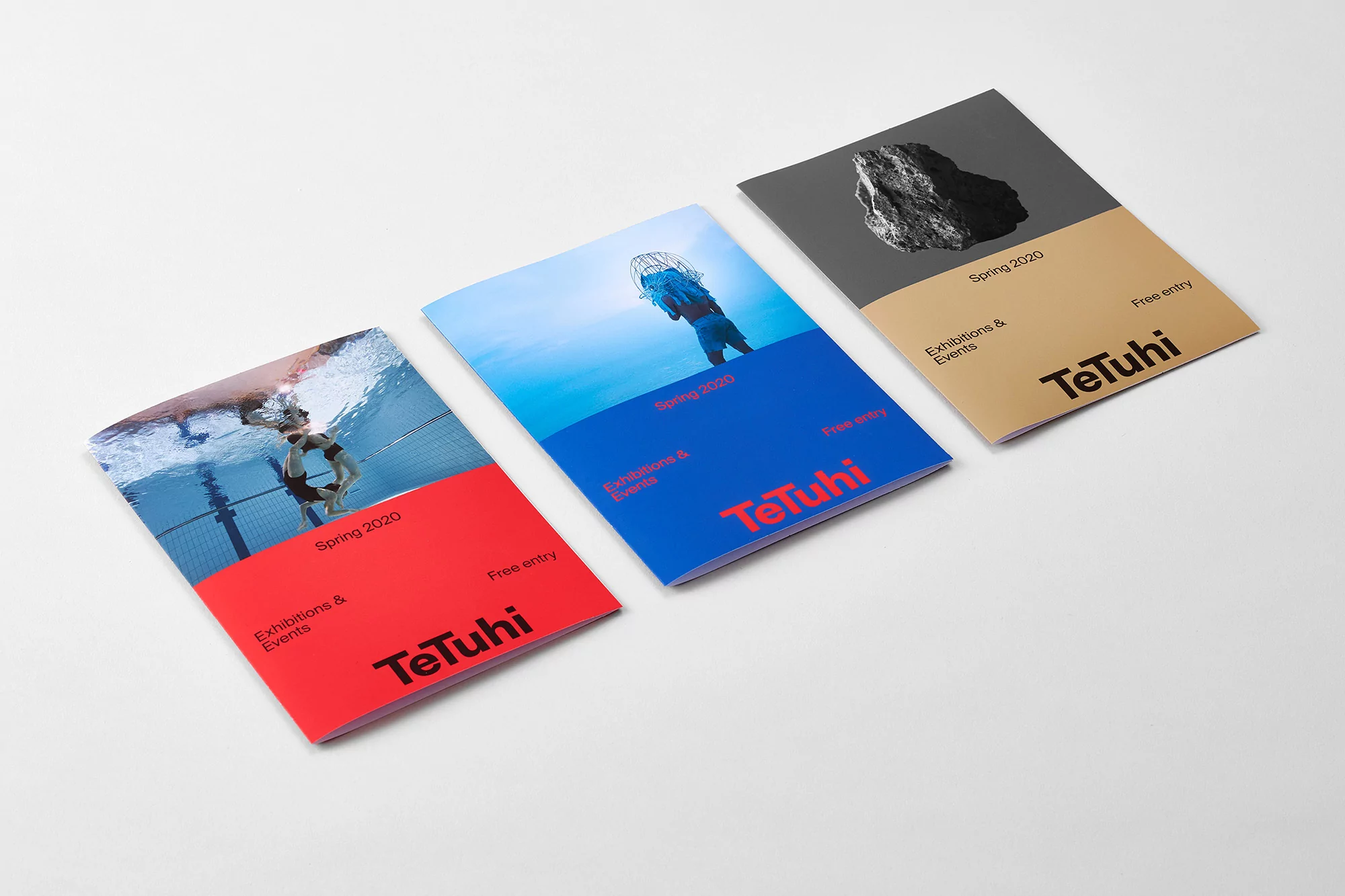 Three TeTuhi exhibition catalogs featuring photography: swimmers in a pool, a jellyfish diver, and a rocky texture on neutral backdrop.