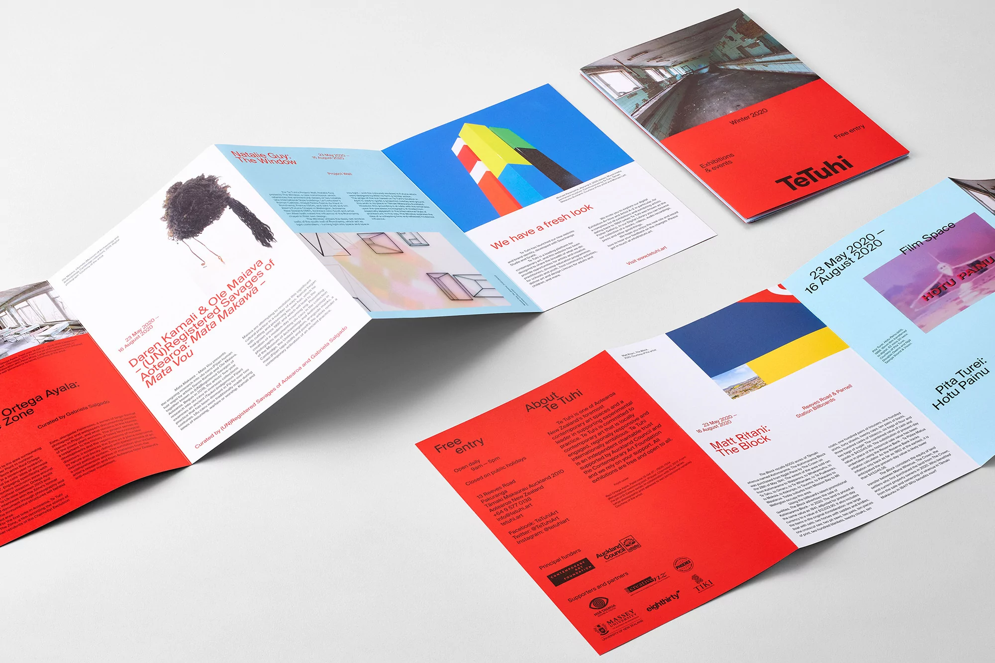 Multiple Te Tuhi brochures displayed on a white surface featuring vibrant colors and striking graphic design elements, offering visual appeal.