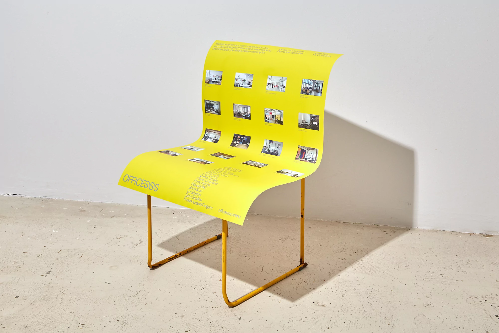 Yellow chair made of a poster with images of office spaces and text, presented against a white background with the legs of the chair in yellow metal.