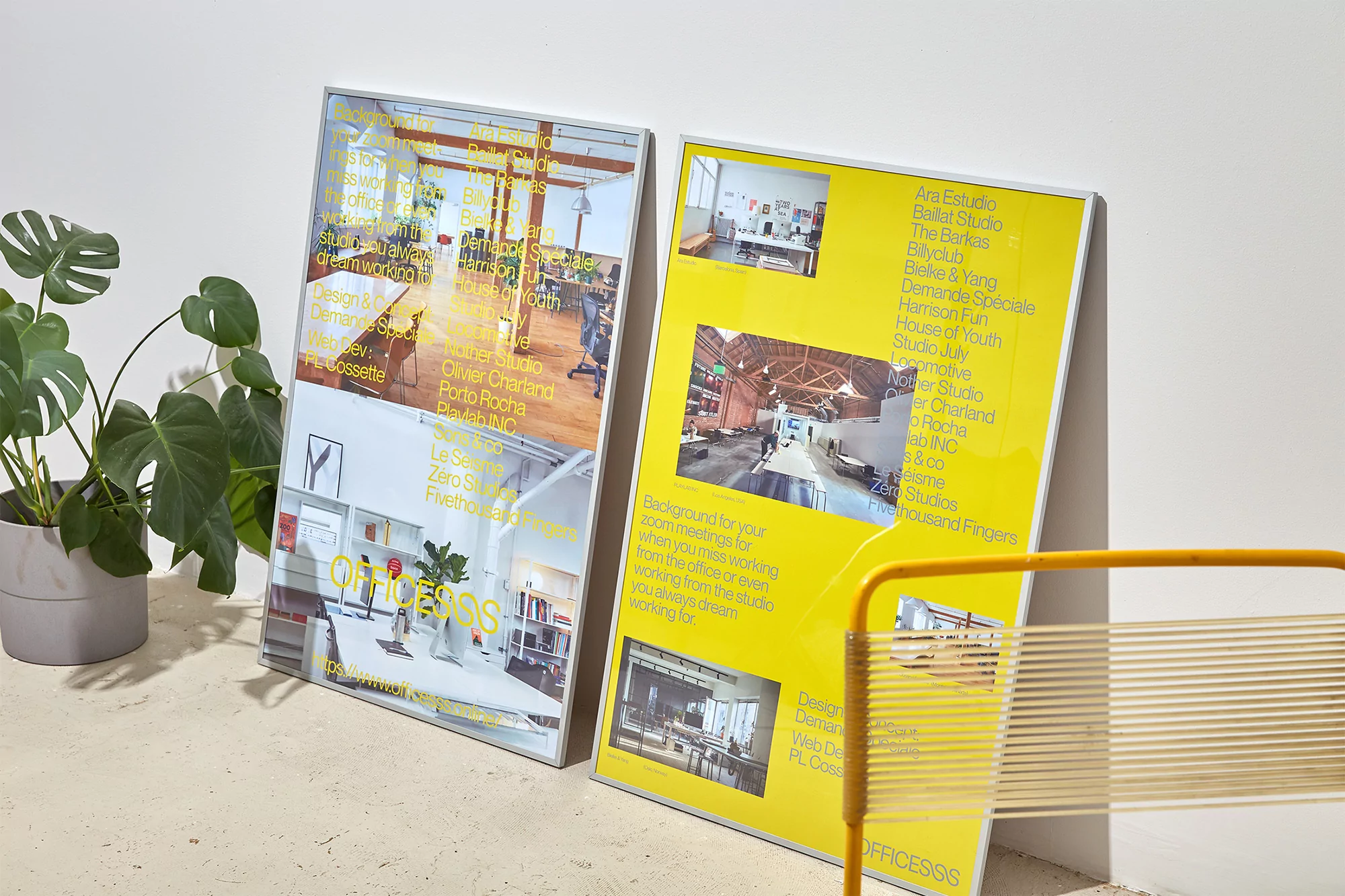 Two framed posters leaned against a wall, showcasing office interiors and brand names, with a monstera plant and yellow chair visible.