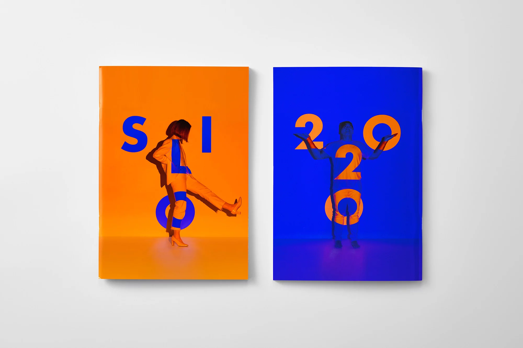 Two vibrant book covers present cut-out figures; one in motion on orange with 'SOLO', the other a poised form on blue with '2020'.
