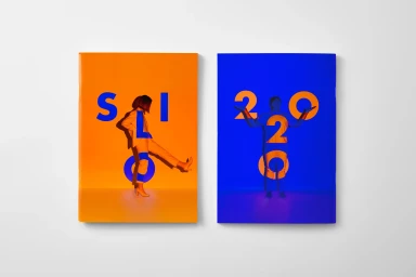 Two rectangular book covers on white surface, one orange with blue typography and one blue with orange typography