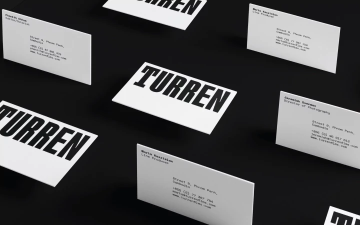 Business cards for Turren films featuring names and contact information arranged on a black background, high contrast, minimalist design.