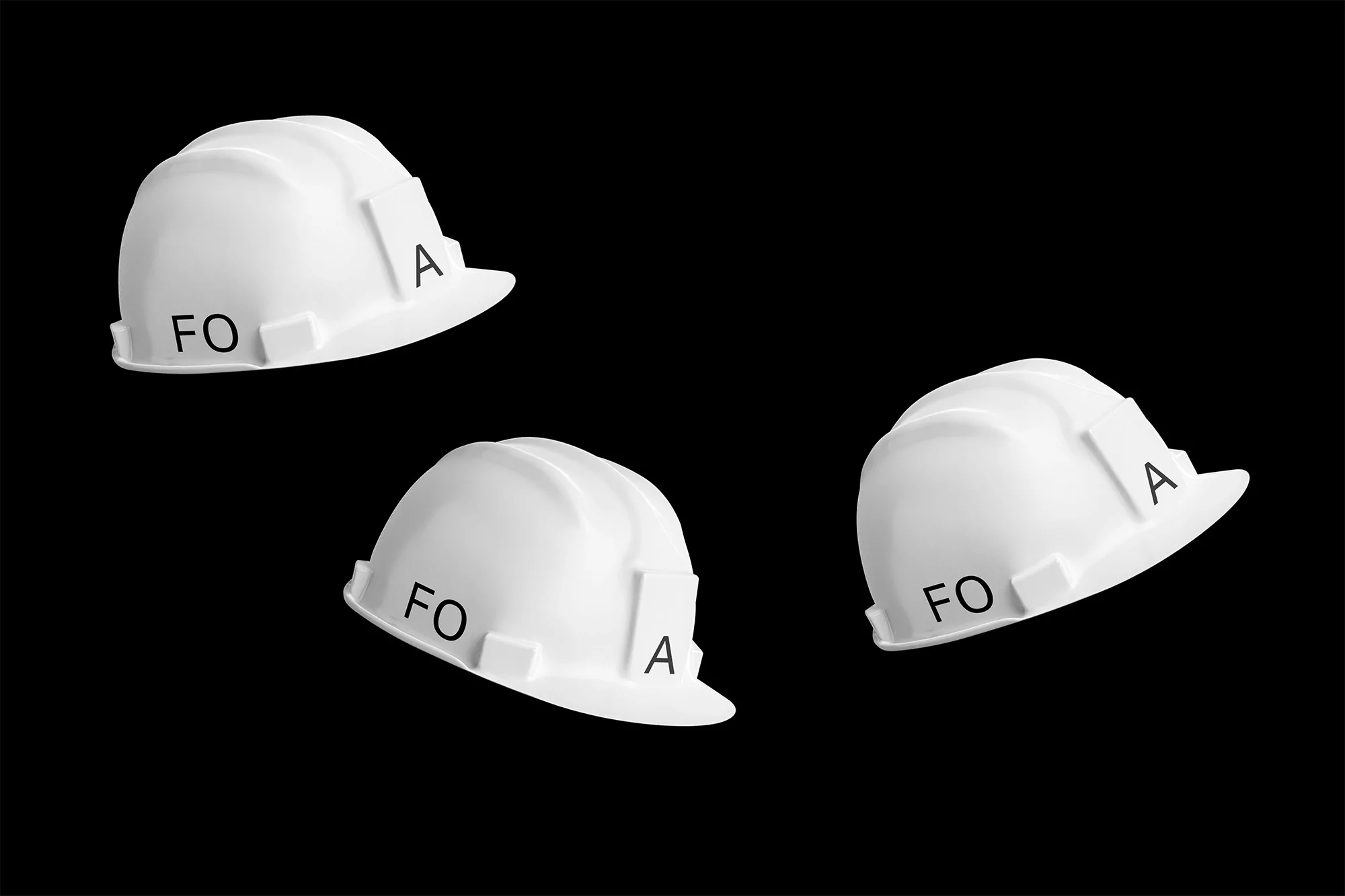 Three white construction hats are displayed against a black background, each bearing the letters 'FO' and 'A' printed in black.