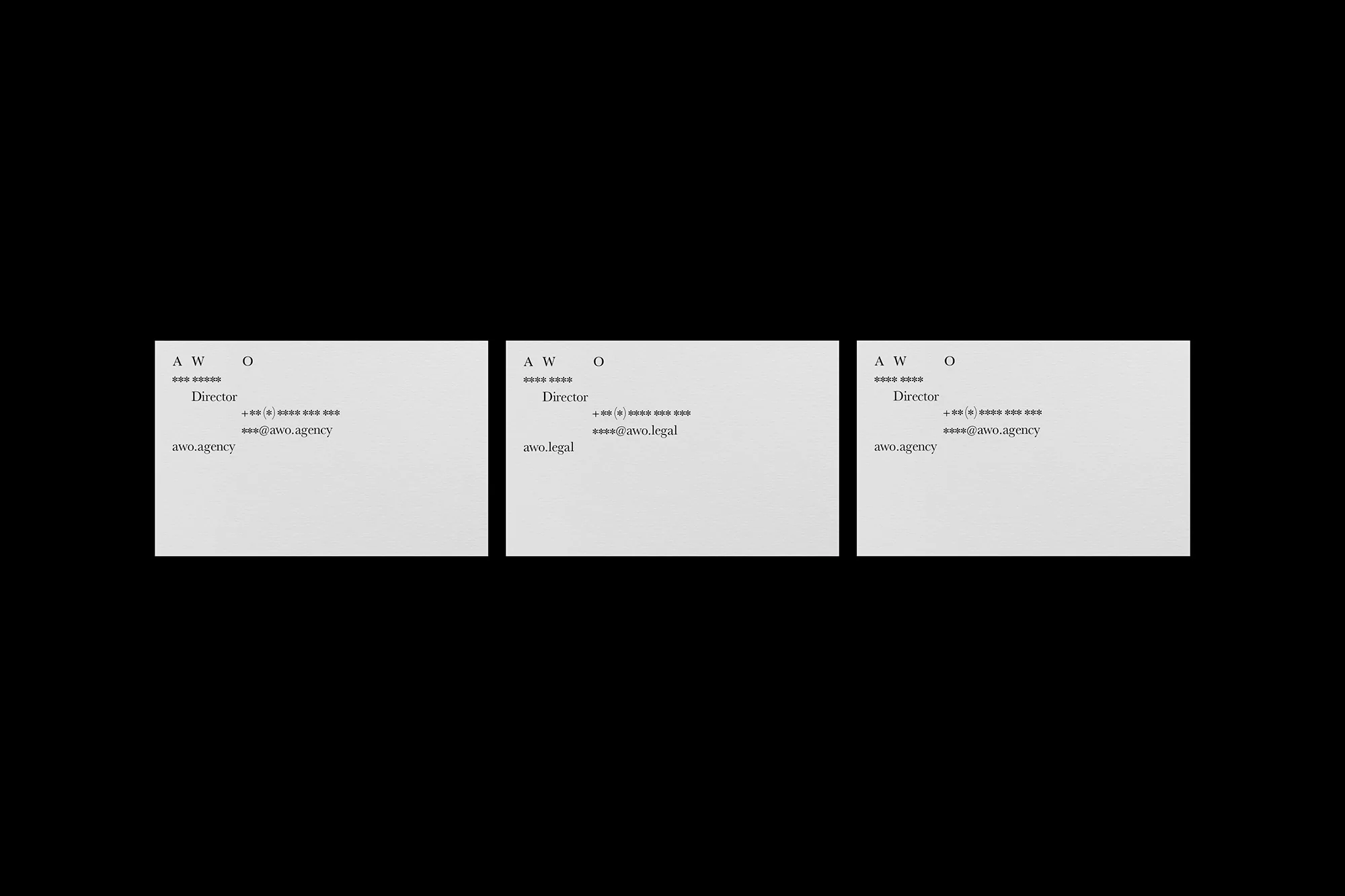 Three business cards with AWO logo, Director title, phone number, and email address against a black background in a studio setup.