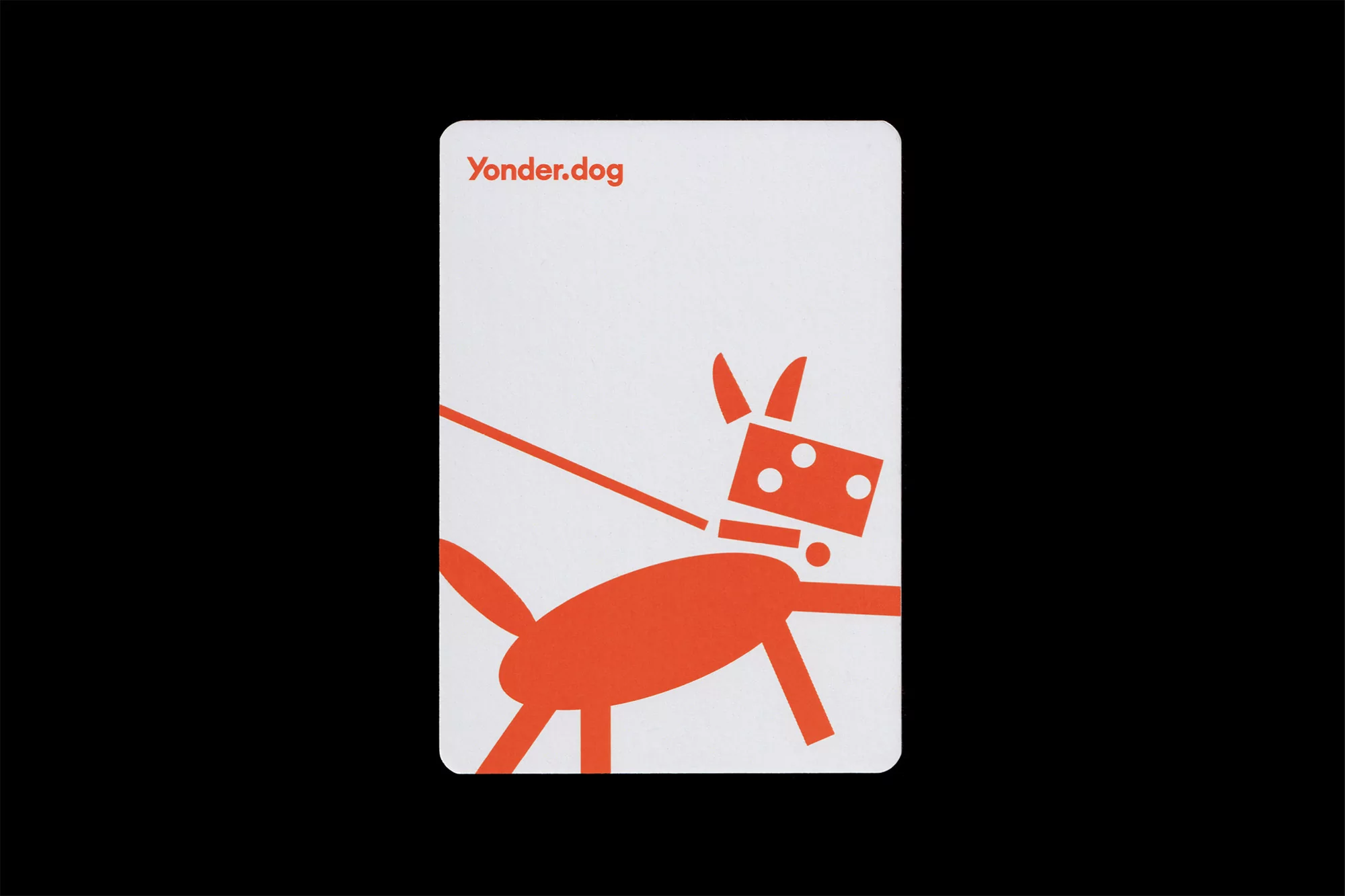 Orange geometric dog illustration on a white business card against a black background, simple and modern design, flat lay.
