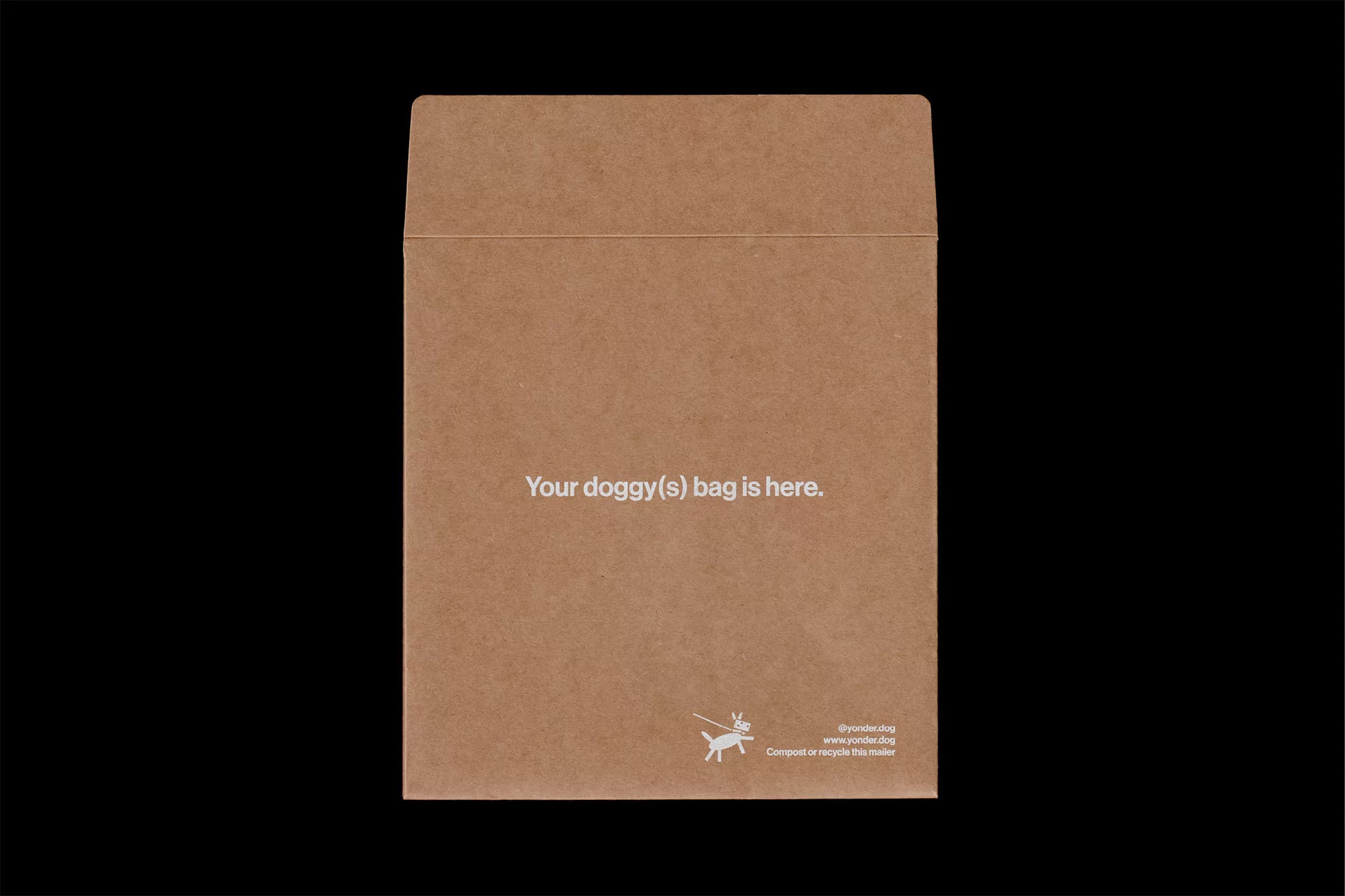 Tan-colored envelope with text about dog waste bags against a black background. Packaging with pet waste disposal information.