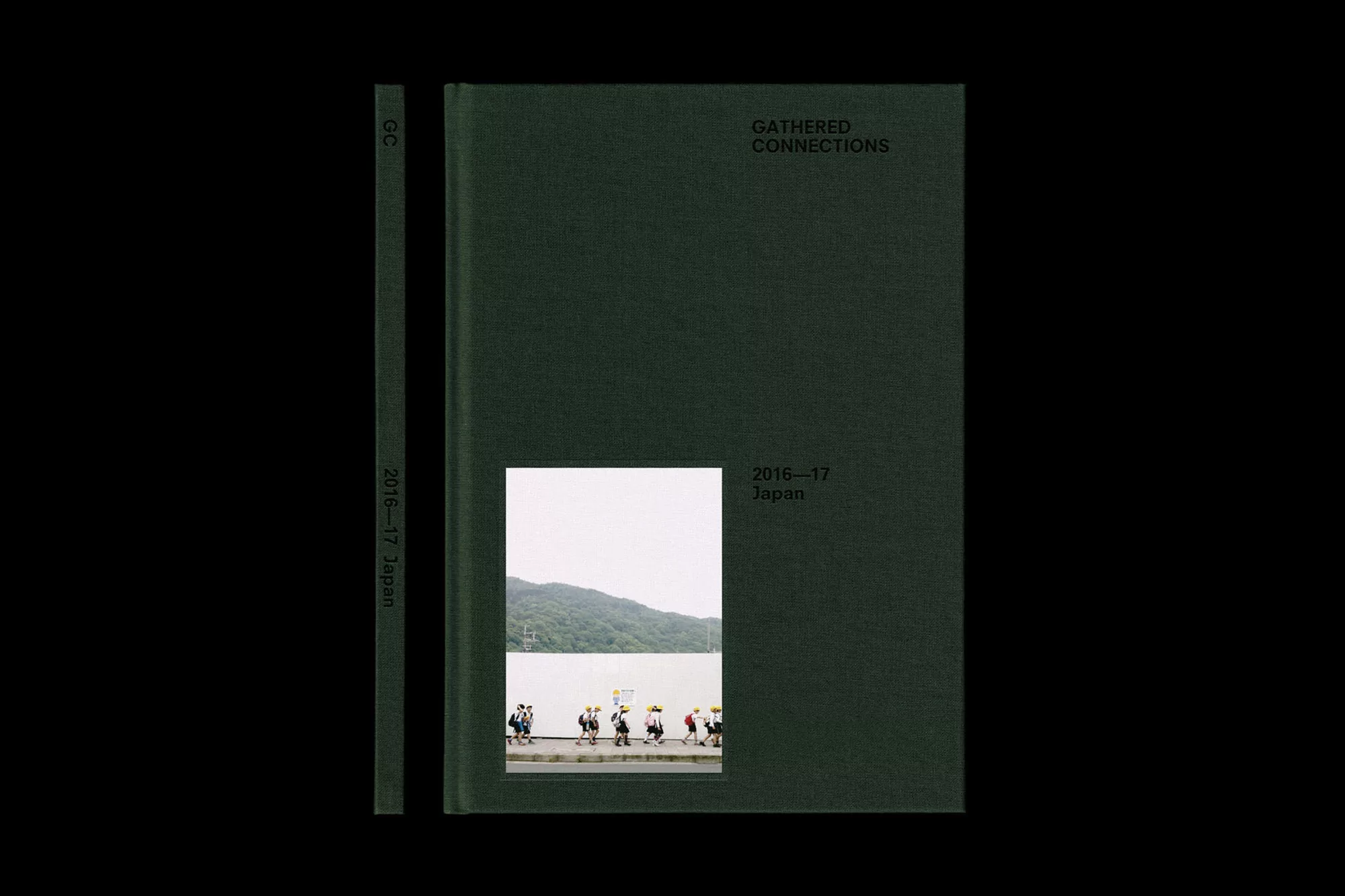 A dark green hardcover book titled 'Gathered Connections' sits next to its spine, revealing a photo of people walking by water.