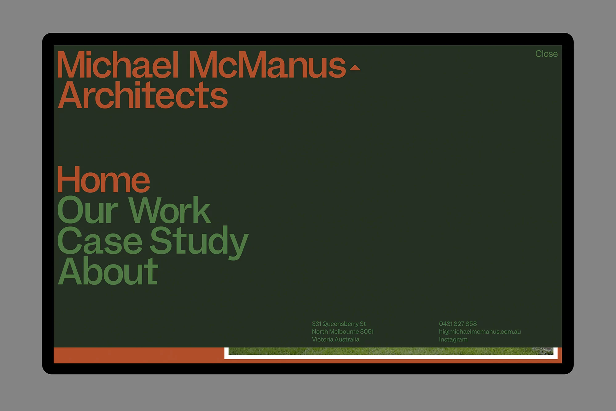 Digital screen with architectural website featuring text 'Michael McManus Architects,' navigation, and contact information, presented in bold fonts.