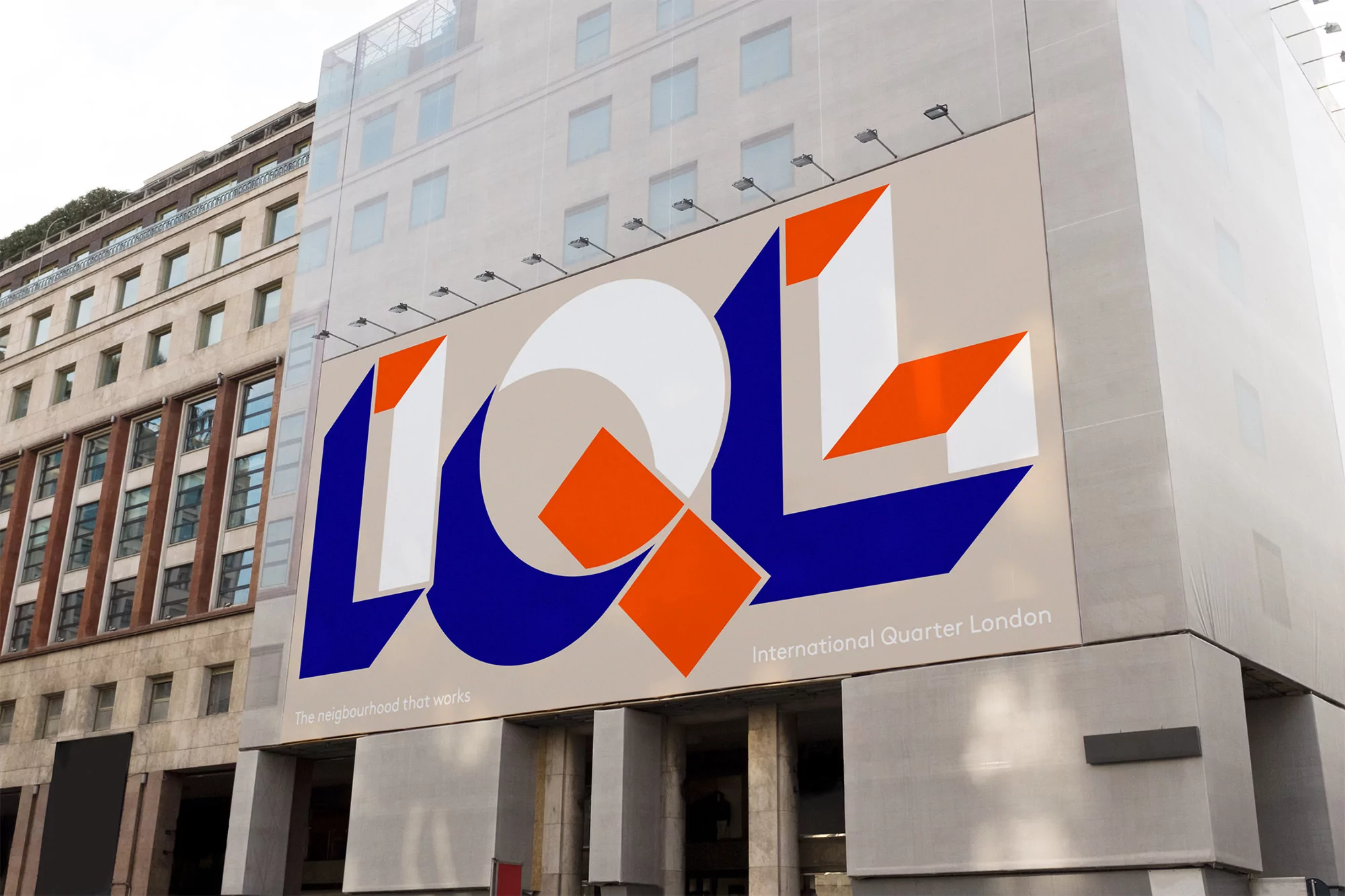 Building facade with large artistic geometric billboard featuring blue, white, and orange shapes, promoting International Quarter London.