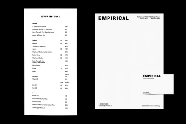 Empirical brand identity collateral showing black typography on white paper against a black background