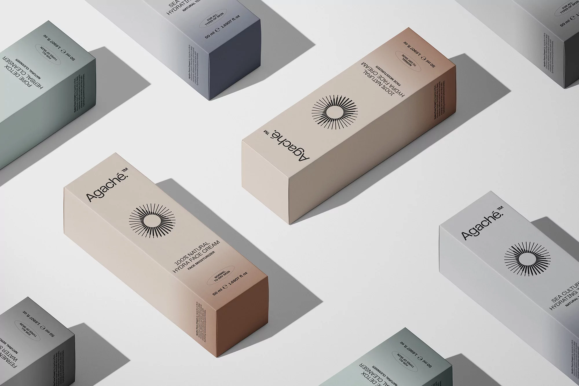 Various pastel-colored cosmetic product boxes arranged on a clean white surface, showcasing skincare and herbal cleanser packaging.