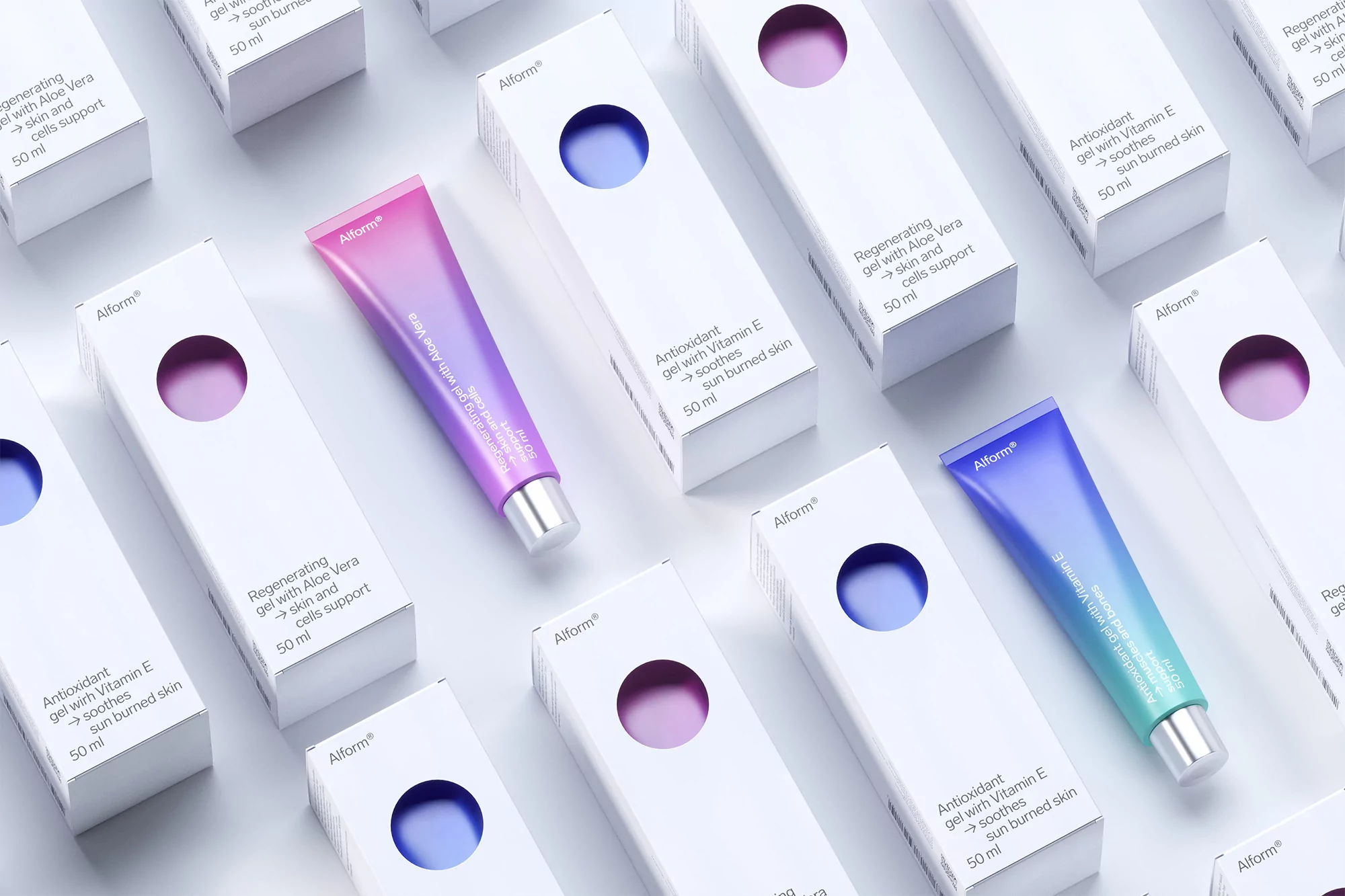 Close-up of gradient color cosmetic tubes and white product boxes arranged on a bright white surface in a repeated pattern.