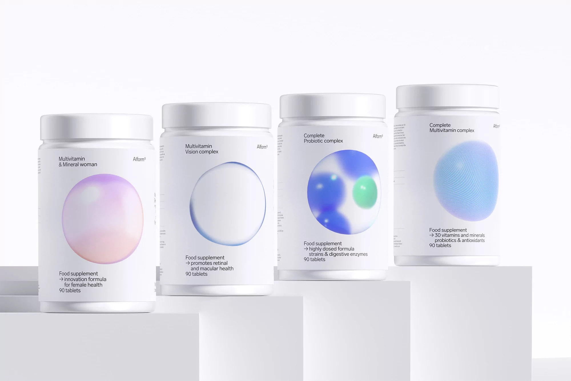 Four white supplement containers, each with different colored graphic circles and labels, arranged on a white cubic display.