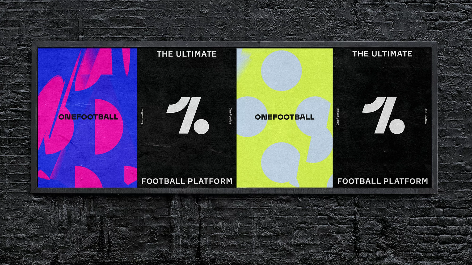 Four football platform posters on a black brick wall. Each poster features the OneFootball logo and branding elements with bold colors.