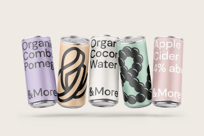 Assortment of colourful aluminum cans featuring various drink names and designs against a neutral background. Beverage container studio shot.