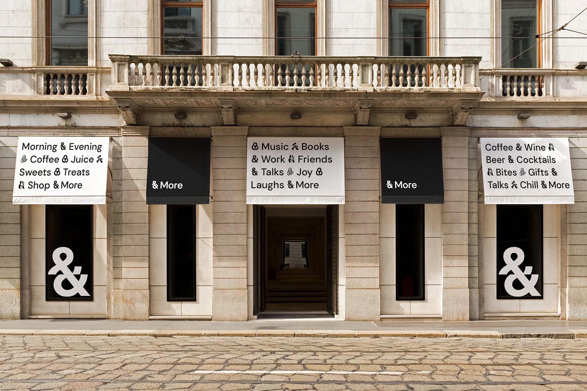 Exterior view of a commercial building with awnings displaying the '& More' logo above the windows, providing services like coffee and books.