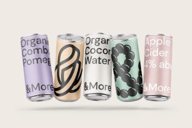 Five assorted beverage cans with condensation floating horizontally against a plain cream background