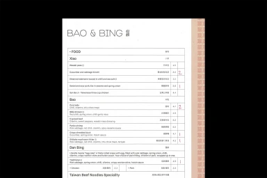 Bao & Bing restaurant menu featuring food categories with prices and handwritten red notations on a white paper layout.