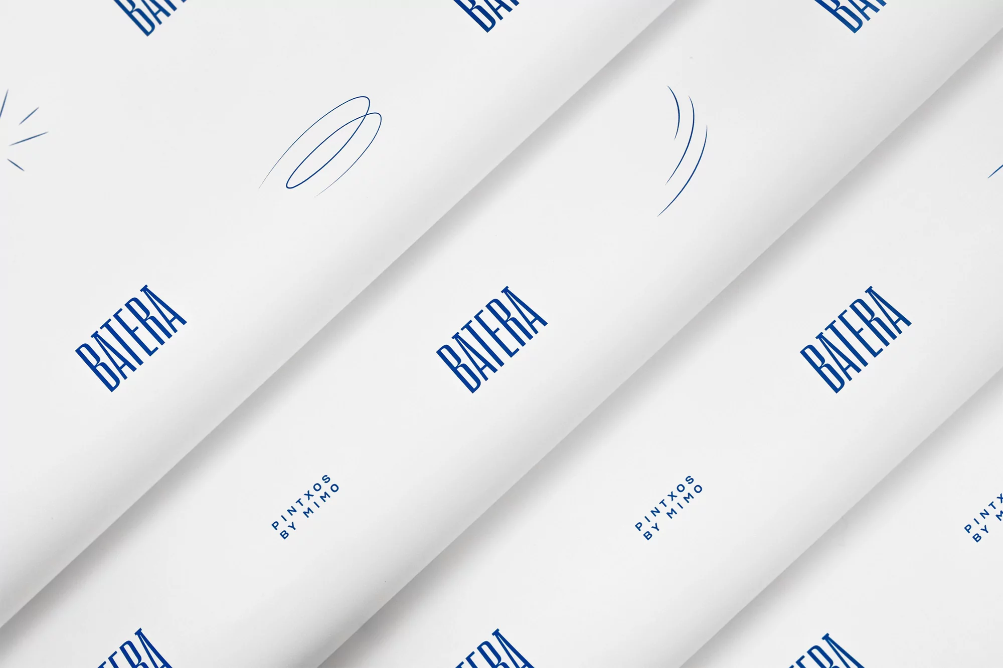 Close-up of white paper with diagonal folds, featuring a repeating dark blue logo and abstract geometric patterns.
