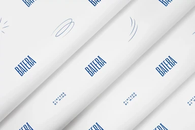 Diagonal repeating pattern of Batera brand identity elements with blue typography and line illustrations on white paper.
