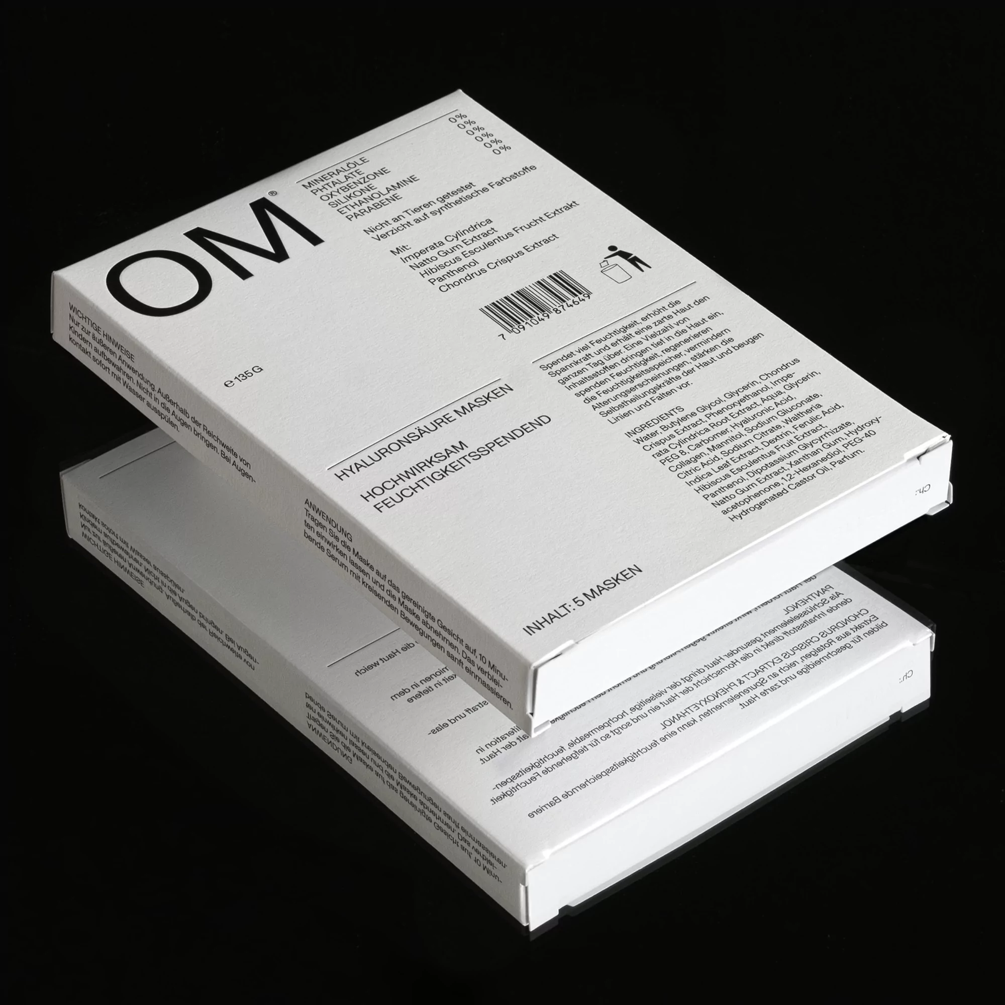 Two white boxes of Hyaluronsaure Masken Hochwirksam Feuchtigkeitsspendend, cosmetic face masks, are stacked on a black surface.