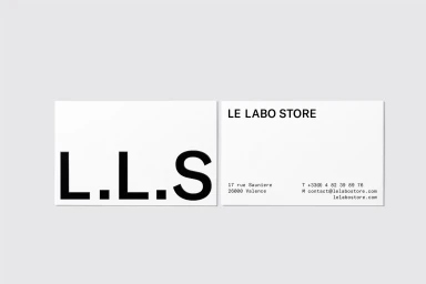 Minimalist business cards for Le Labo featuring bold black typography on white paper set against a plain light grey backdrop.