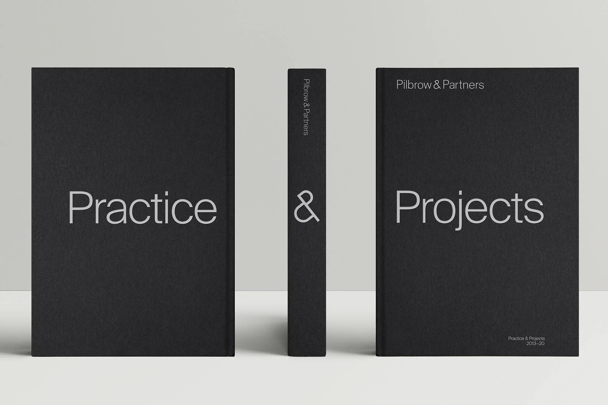 Three black hardcover books aligned on a white surface, two showing front covers with titles 'Practice' and 'Projects'.
