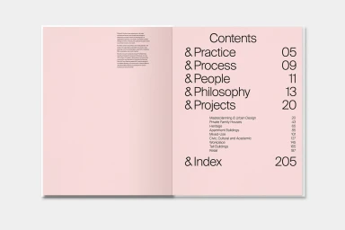 Open book spread showing a table of contents with bold sans-serif typography against a pale pink background.