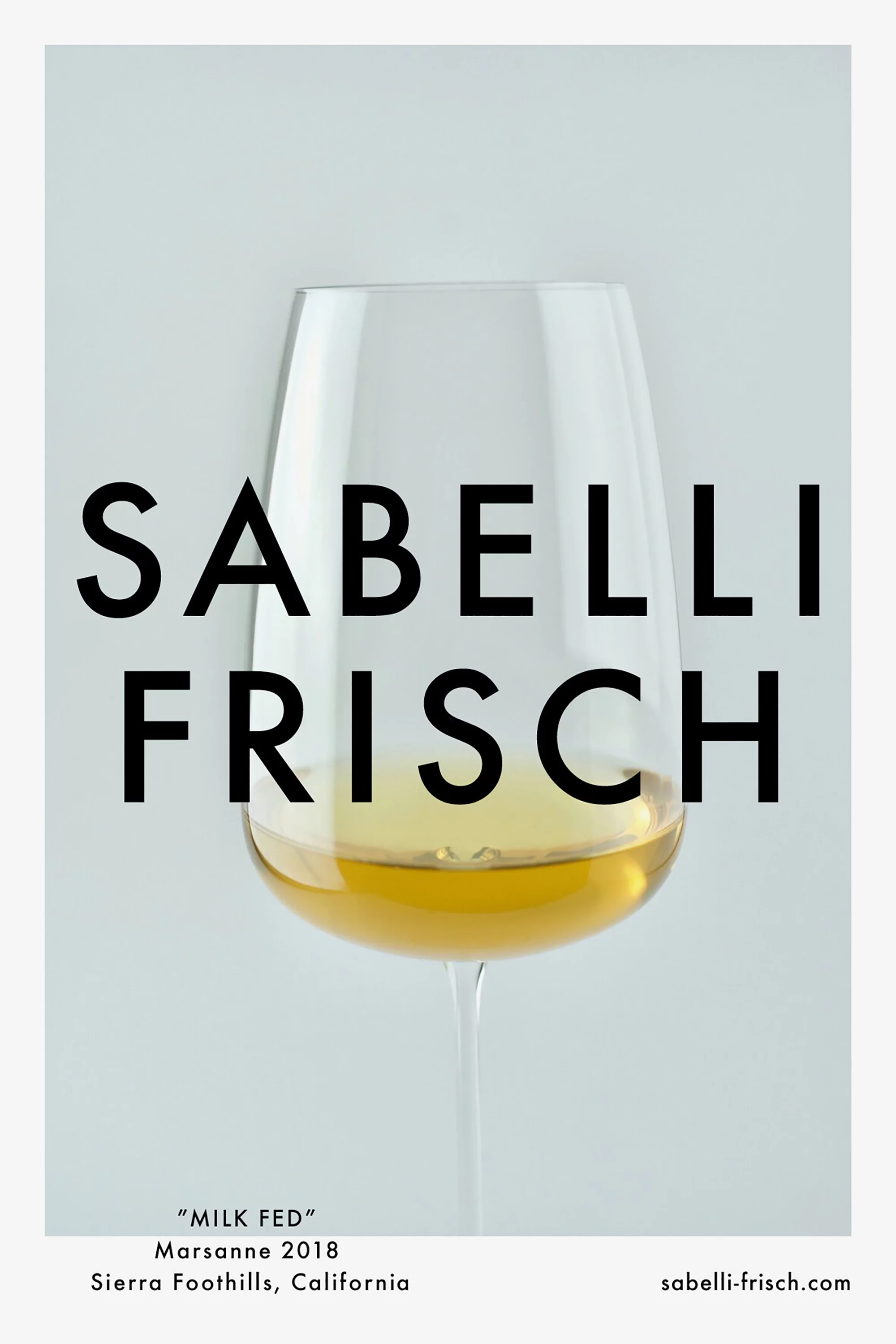 Wine glass with yellow liquid and Sabelli Frisch text label on a gray background in a studio shot for food and beverage use.