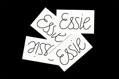 Four rectangular white paper cards featuring the word Essie in a flowing script font arranged flat against a black background