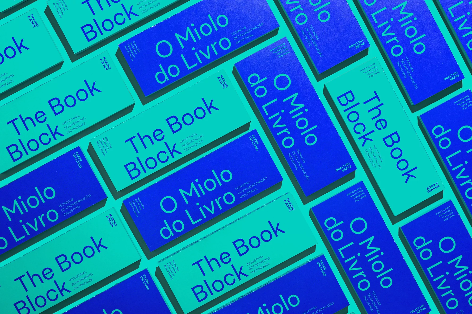 Overhead shot featuring several book covers in alternating colors of blue and light teal, with text in contrasting colors, arranged in rows.