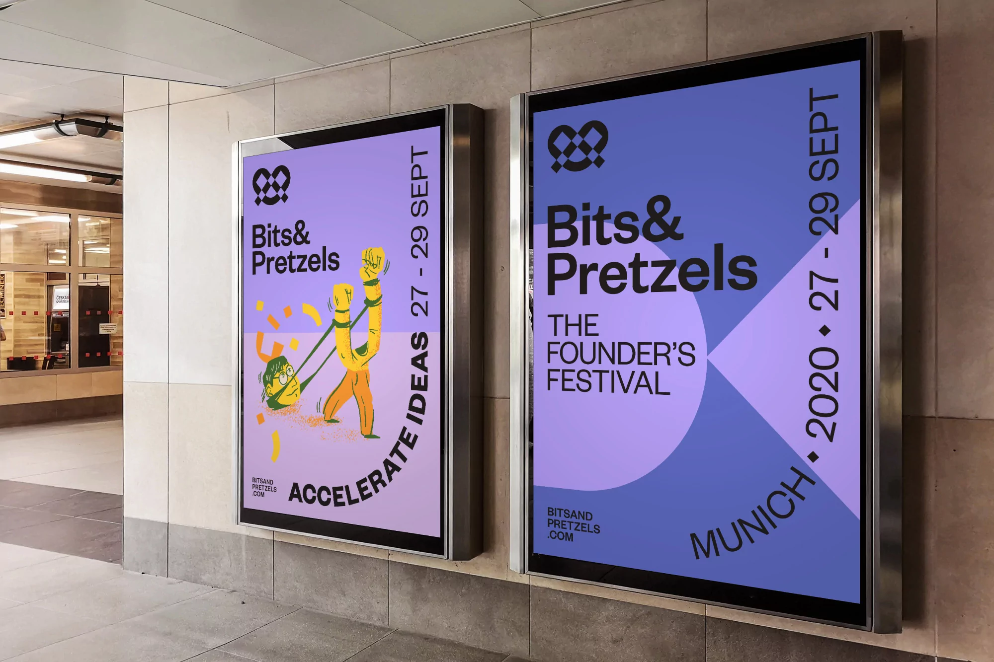 Two colorful promotional posters advertise the Bits & Pretzels festival in a public transit area with visible wall and lighting.