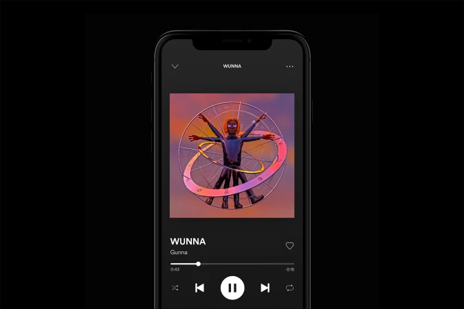 Smartphone displays a stylized album cover art of the artist Gunna, set against a deep black background. Digital album design.