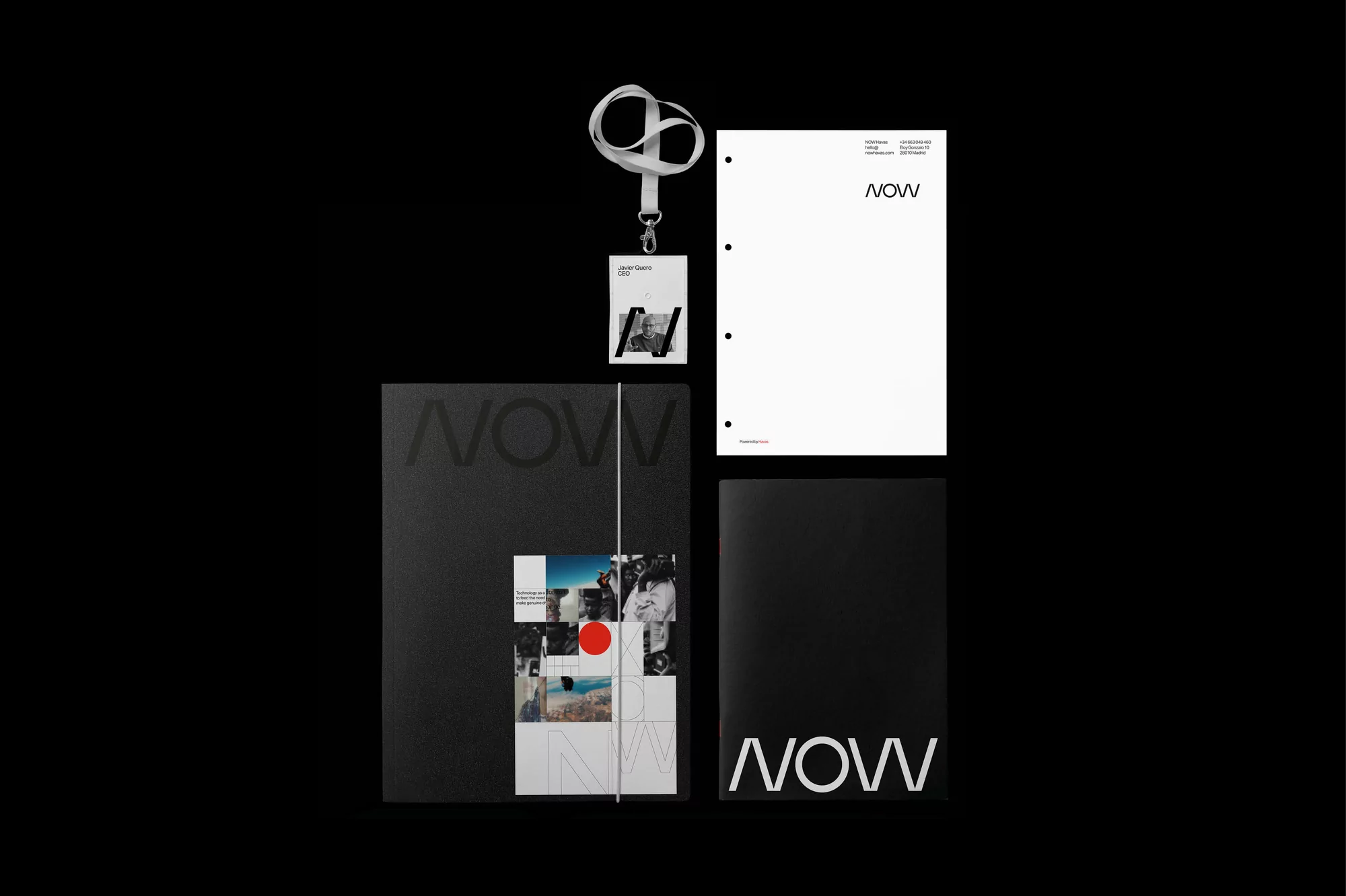 Flat lay of black and white 'NOW' branded marketing materials including a lanyard, notebook, letterhead, and booklet on black backdrop.