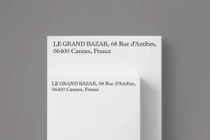 Stacked white rectangular blocks featuring serif typography against a solid grey background