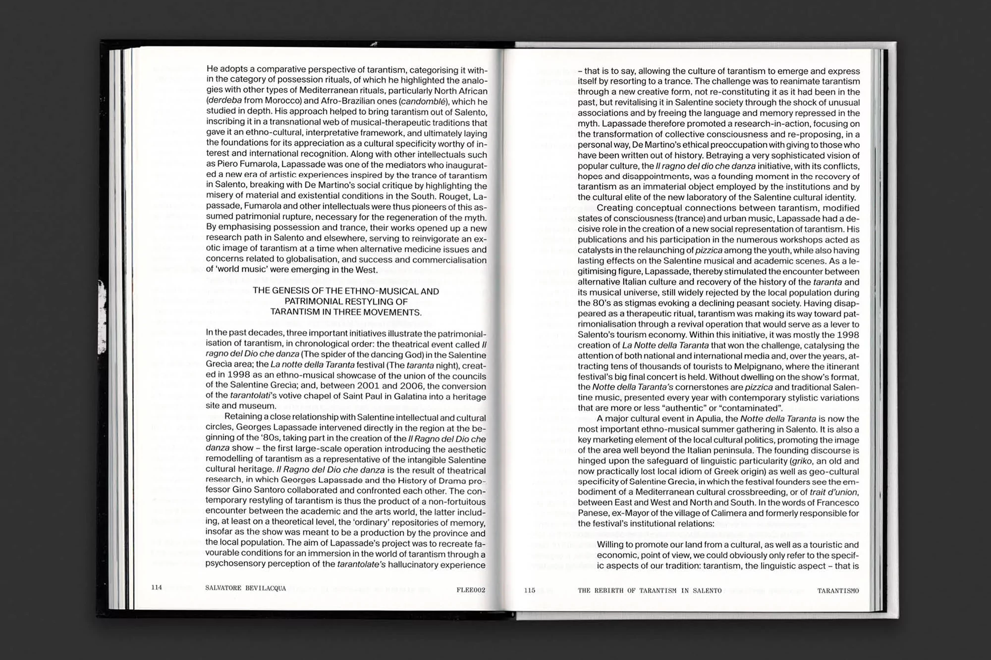 An open book displays two pages of black text printed on white paper, presented against a dark gray background.