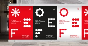 Branded display panels featuring red, black, and white graphic identity designs with circular geometric patterns.