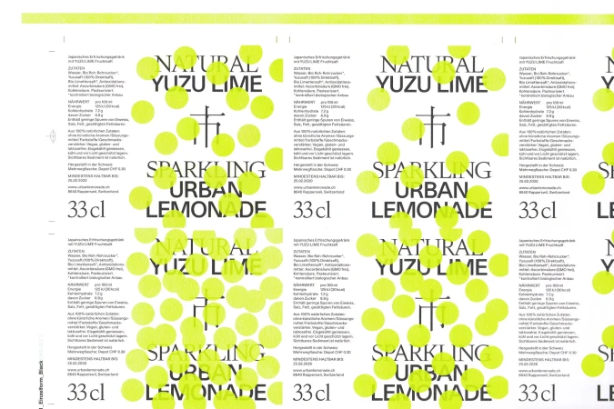 Label featuring the words 'Natural Yuzu Lime Sparkling Urban Lemonade' against a background of yellow dots on a white surface.