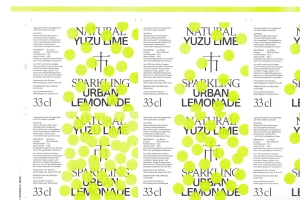 Printed sheet featuring repeating label designs with black typography overlaid with bright lime green circular dots.