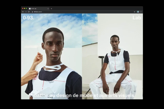 Fashion photography featuring a young Black man in an experimental garment, displayed on a website with a blue sky background.