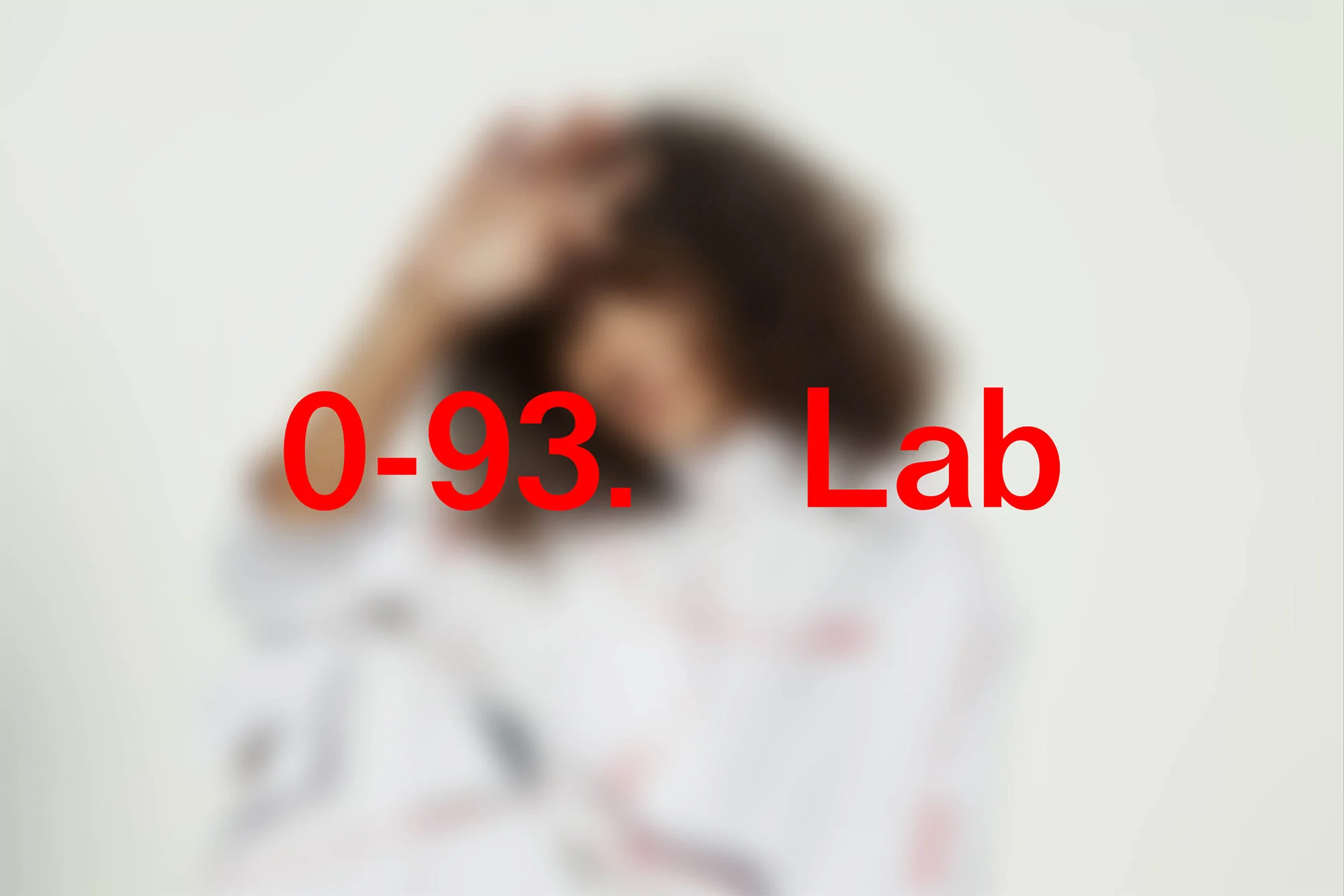 Blurred image of a person with dark curly hair and a white collared shirt in front of a white background with red text overlay.