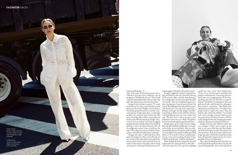 Fashion shot of blonde woman in white lace suit posing near a truck on a city street, wearing sunglasses and a neutral expression.