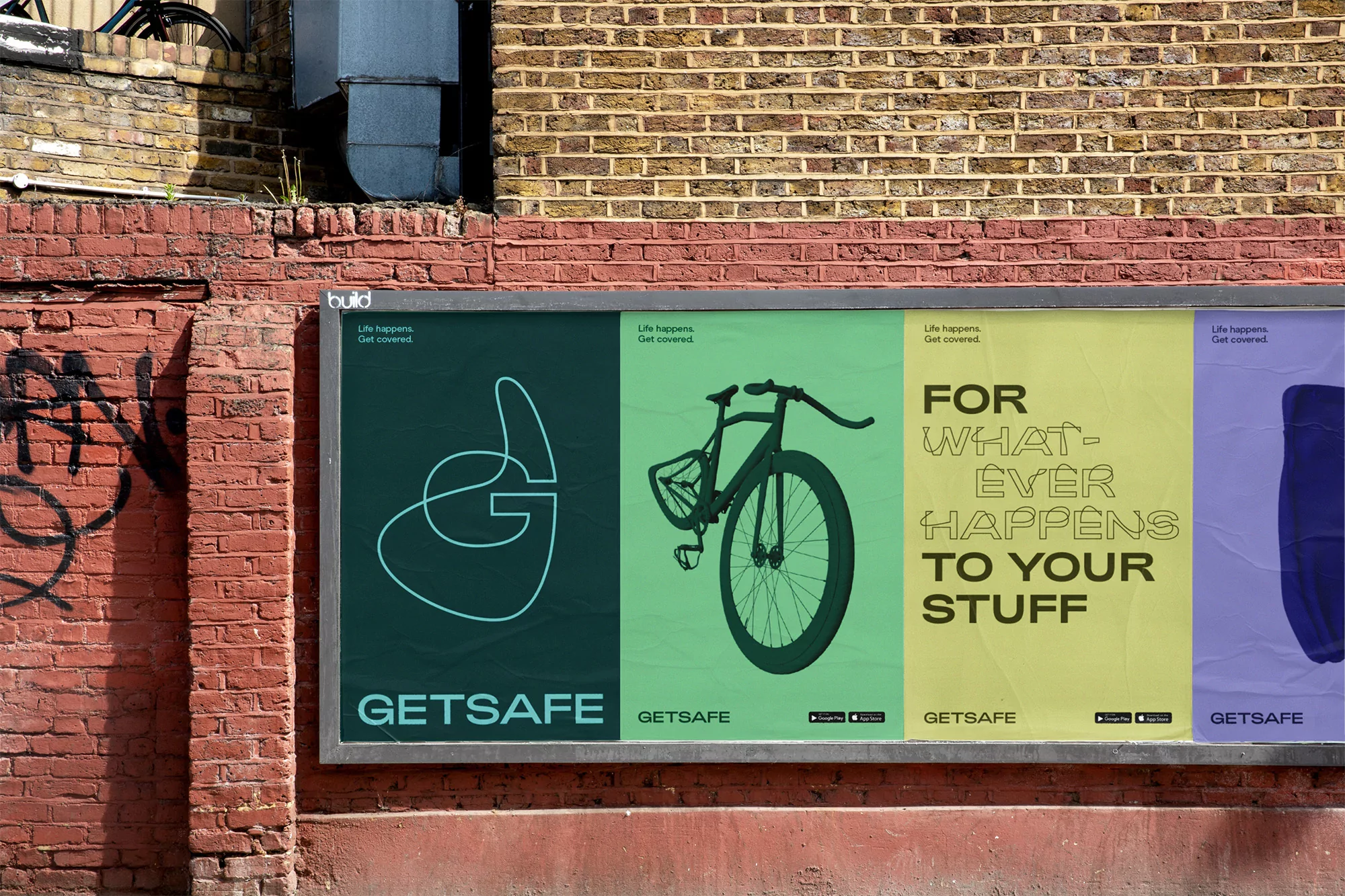 Eye-level shot of a GetSafe insurance billboard featuring abstract graphics and a bicycle displayed against a brick wall in an urban setting.