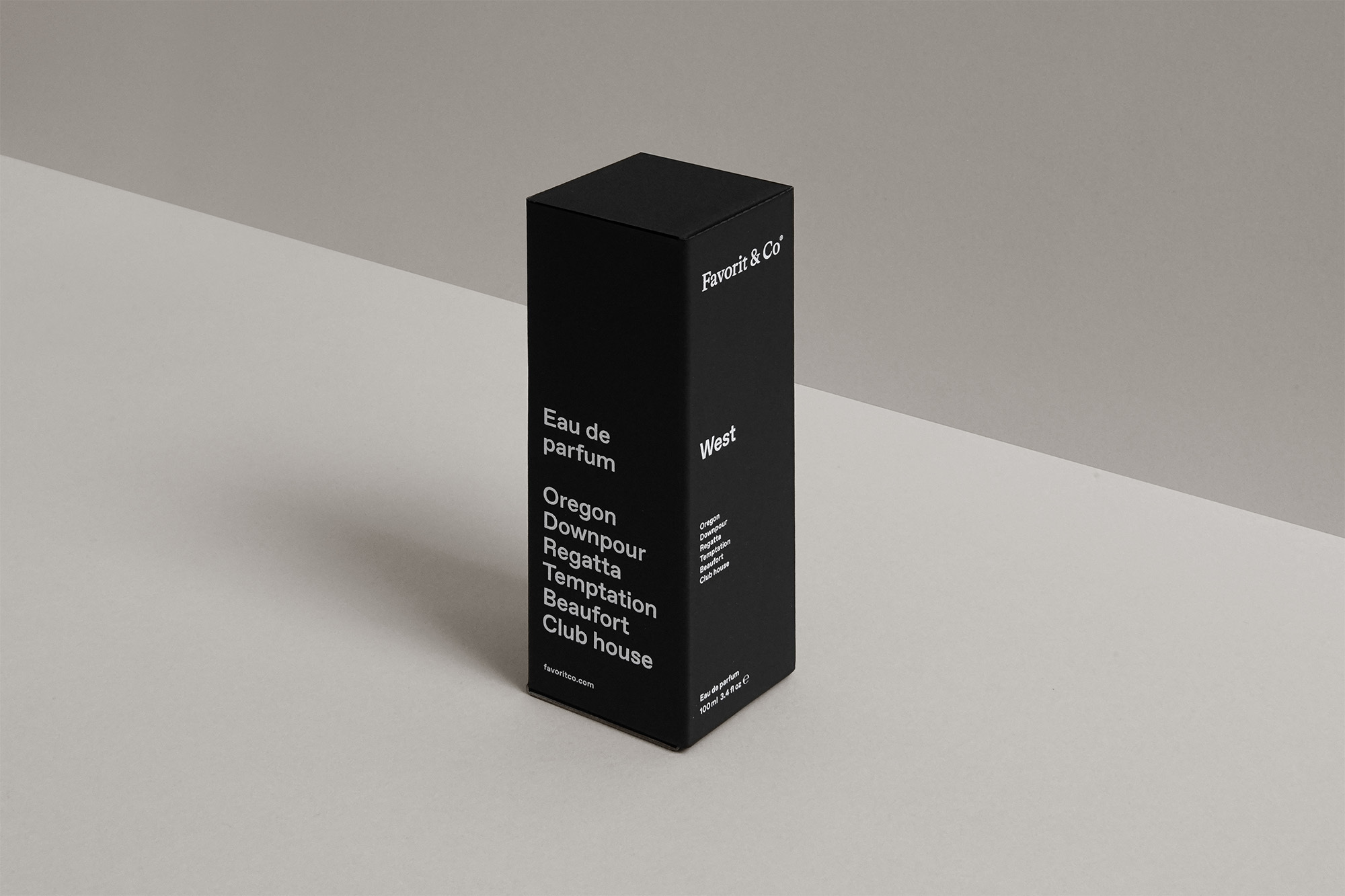 Black box of Favorit & Co Eau de parfum on an off-white surface, angled, with visible text, creating a minimalist and elegant product shot.
