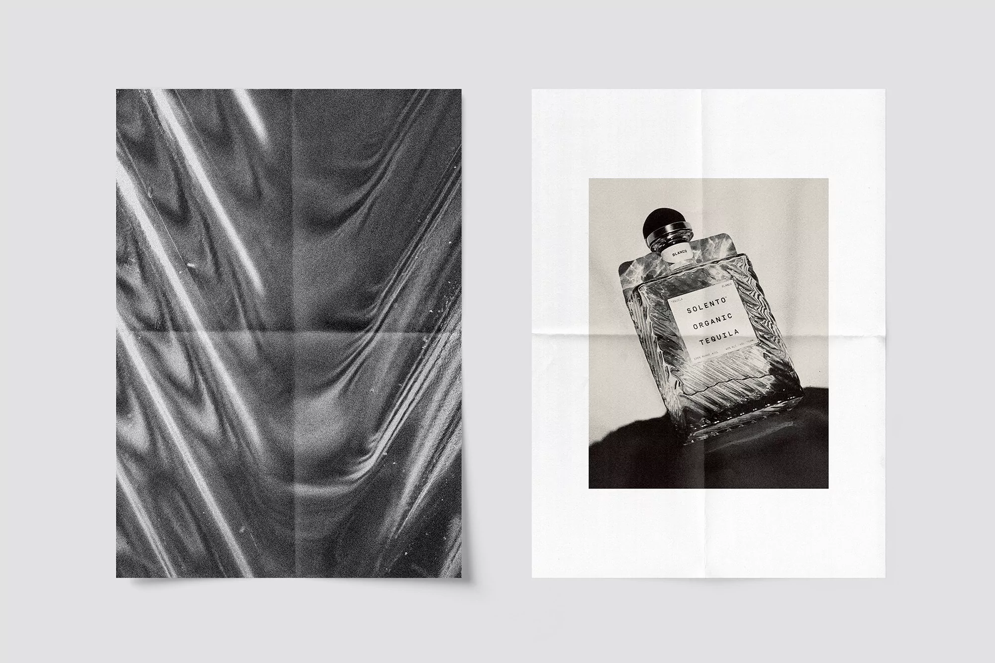 Monochromatic advertisement for Solento Organic Tequila features a product bottle on a poster with a textured plastic-wrapped poster.